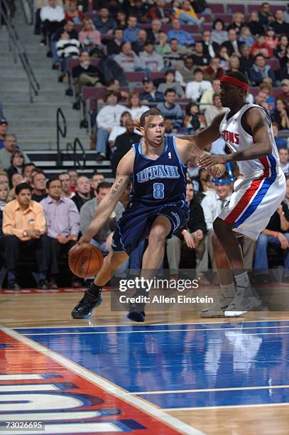 Deron Williams of the Utah Jazz drives around Flip Murray of the Detroit Pistons on January 17, 2007 at the Palace of Auburn Hills in Auburn Hills,...