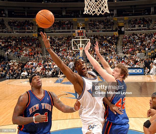 Antawn Jamison of the Washington WIzards goes to the basket against David Lee and Eddy Curry of the New York Knicks on January 17, 2007 at the...