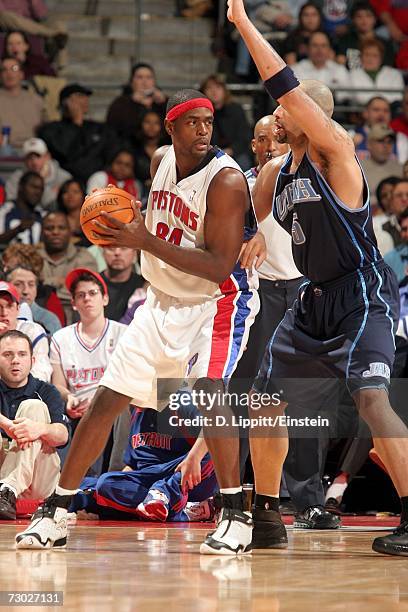 Chris Webber of the Detroit Pistons backs down against Carlos Boozer of the Utah Jazz on January 17, 2007 at the Palace of Auburn Hills in Auburn...