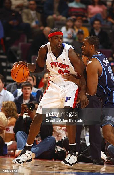 Chris Webber of the Detroit Pistons drives around C.J. Miles of the Utah Jazz on January 17, 2007 at the Palace of Auburn Hills in Auburn Hills,...