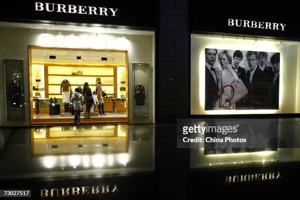 Two women walk into a Burberry store on January 17, 2007 in Beijing, China. British luxury goods retailer Burberry has recently announced its...