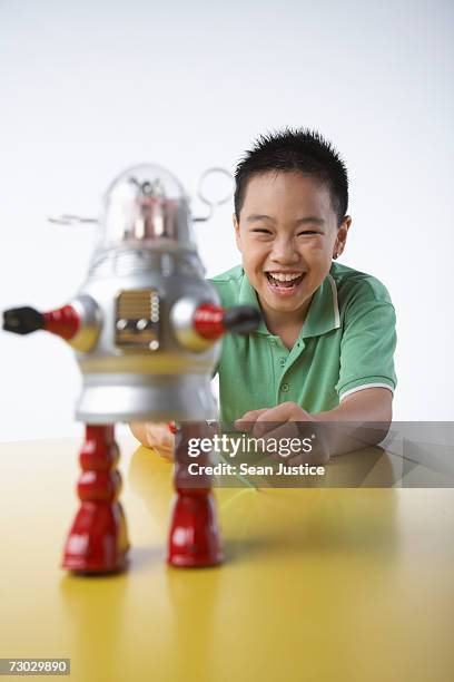 boy (8-10) playing with toy robot - boy 10 11 stock pictures, royalty-free photos & images