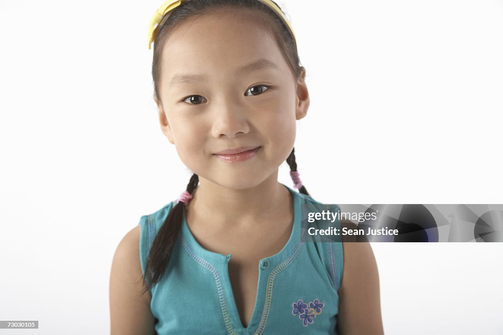 Girl (5-7) smiling, portrait