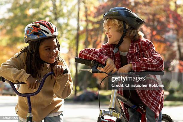 smiling boy (8-9) and girl (6-7) standing at bicycle in park, smiling - open day 8 bildbanksfoton och bilder