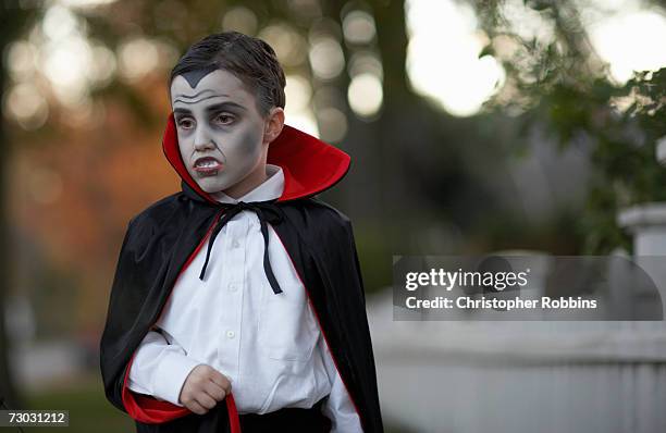 boy (6-7) dressed as vampire standing outdoors - count dracula stock pictures, royalty-free photos & images