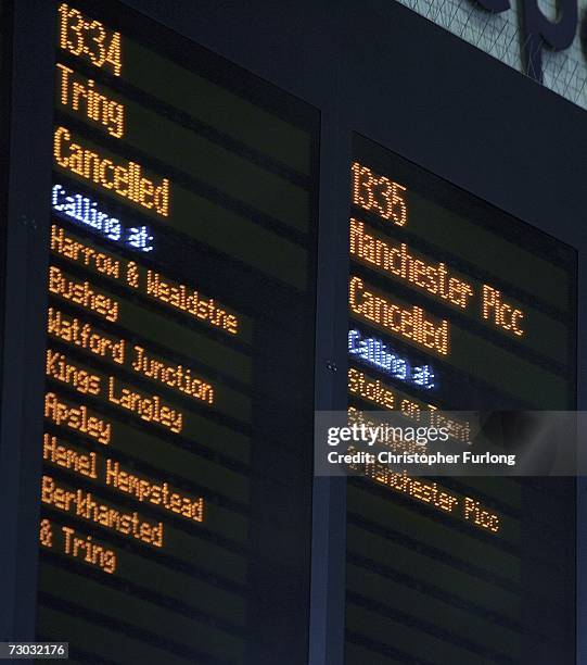 The departure board shows some of the cancelled trains from London Euston train station leaving passengers to sit and wait as mainline services are...