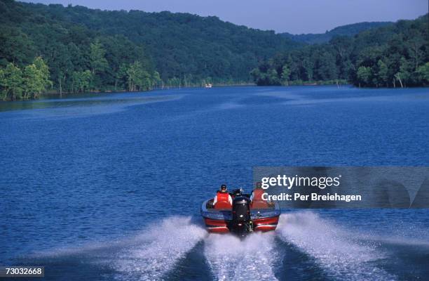 two men in motorboat on lake, rear view, table rock lake, branson missouri, usa - branson stock pictures, royalty-free photos & images