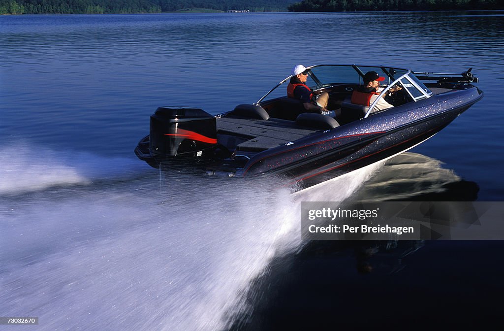 Two men in motorboat on lake, Table Rock Lake, Branson Missouri, USA