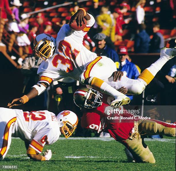 James Wilder of the Tampa Bay Buccaneers being upended during a game against the San Francisco 49ers on November 18, l984 in san Francisco,...