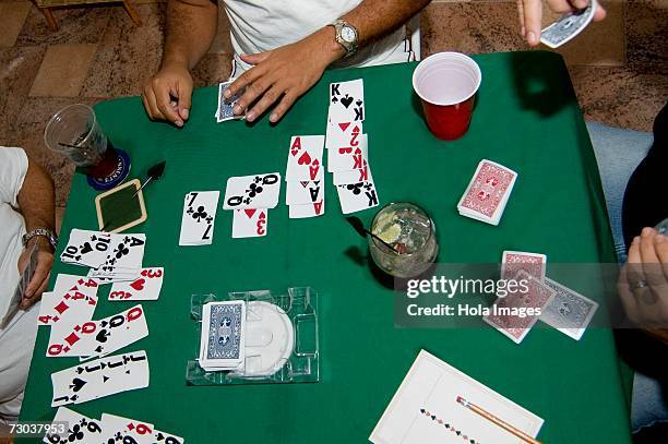 high angle view of three people playing cards - ace of clubs stock pictures, royalty-free photos & images