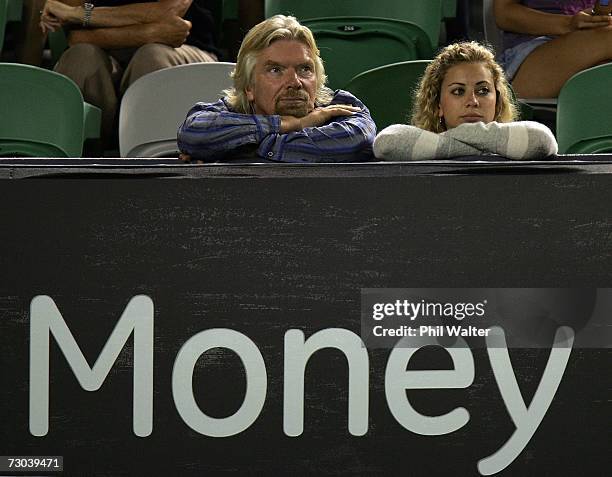 Sir Richard Branson and his daughter Holly Branson watch the third round match between Serena Williams of the USA and Nadia Petrova of Russia on day...