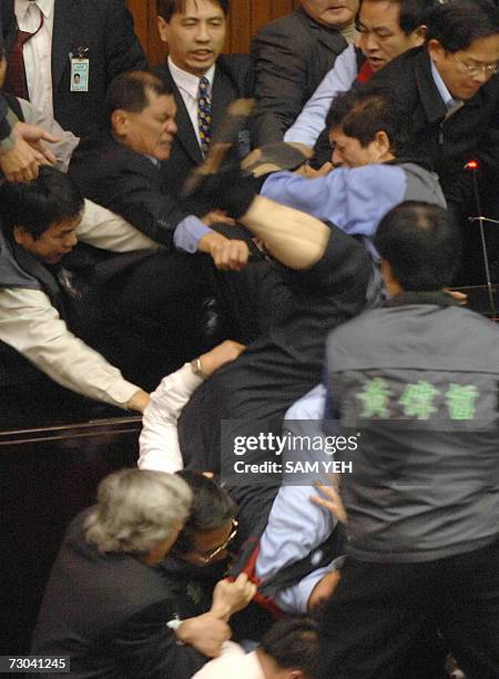 An unidentified legislator , from the ruling Democratic Progressive Party , falls down from the speaker's podium during a demonstration at the...