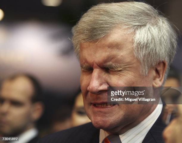 German Agriculture and Consumer Protection Minister Horst Seehofer reacts after drinking some liqueur as he tours the 72nd International Gruene Woche...