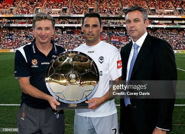 Ben Buckley, CEO, Football Federation Australia presents Ernie Merrick and Kevin Muscat of the Victory the Minor premiership trophy before the round...
