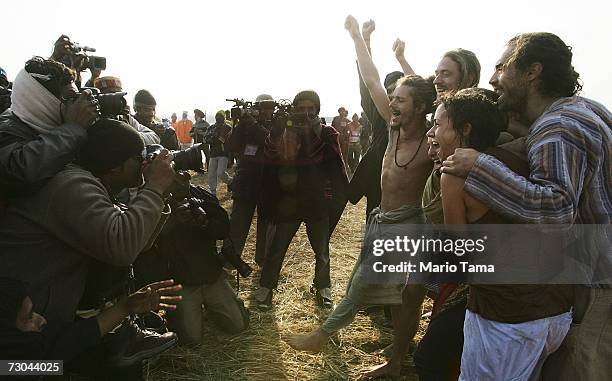 Indian photographers takes pictures of Western tourists including Mark Wiseberg from Manchester, England after they took a holy dip at the ritual...