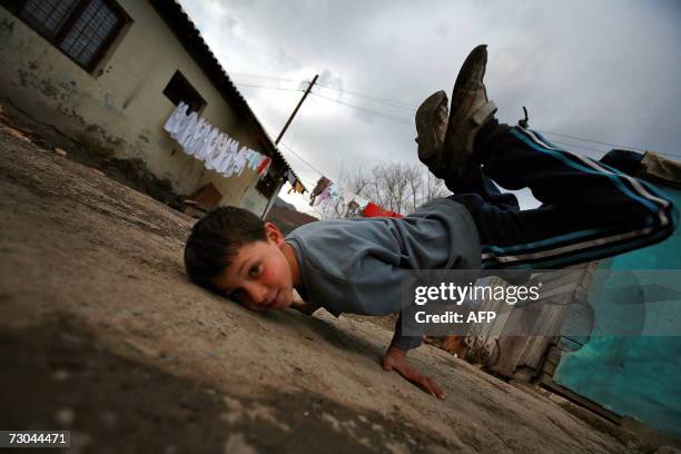 Roma boy practices breakdance in the Zitkovac refugee camp in North Mitrovica, 19 January 2007. 40 families and 100 children live there near toxic...