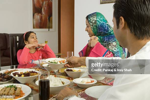 arab family of four dining - hot middle eastern girls stock pictures, royalty-free photos & images