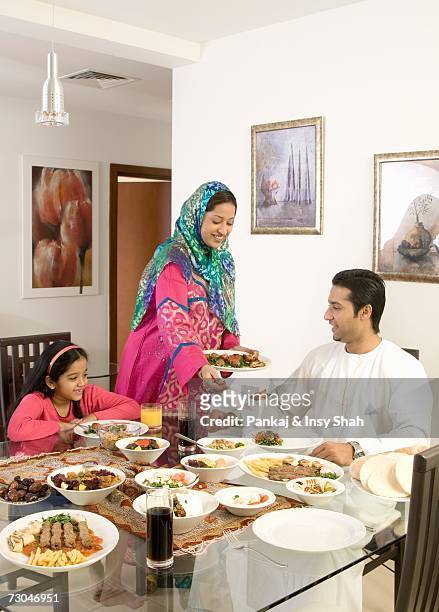 mother serving food to family - hot middle eastern girls stock pictures, royalty-free photos & images