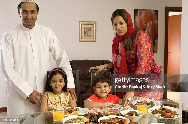 family of four at the dining table - hot middle eastern girls stock pictures, royalty-free photos & images