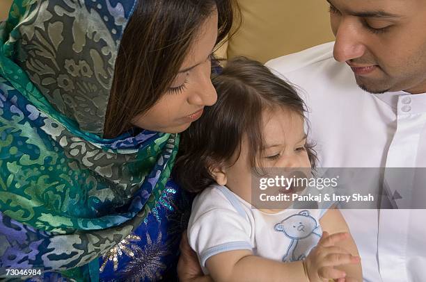 family of three sitting in the living room - hot babe - fotografias e filmes do acervo