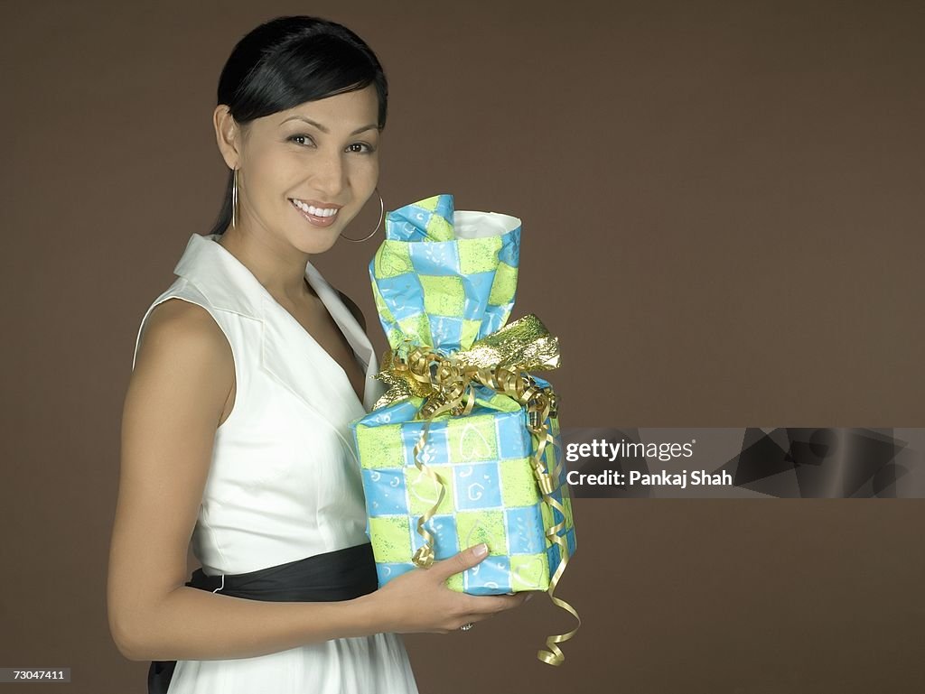 Young woman holding a present