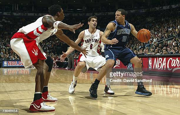 Jose Calderon of the Toronto Raptors and teammate Chris Bosh guard against Deron Williams of the Utah Jazz on January 19, 2007 at the Air Canada...