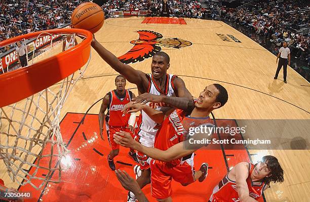 Marvin Williams of the Atlanta Hawks drives to the basket over Ryan Hollins of the Charlotte Bobcats at Philips Arena on January 19, 2007 in Atlanta,...