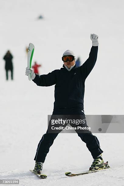 Bearer holds the torch during the torch relay for the 6th Asian Winter Games on January 20, 2007 in Jilin City of Jilin Province, China. Chinese...