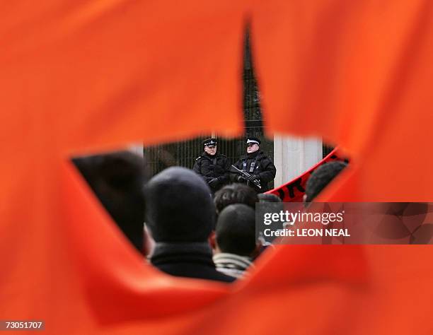 London, UNITED KINGDOM: Armed police watch supporters of the HIzb-Ut-Tahrir, the Islamic political party, gathering outside the American Embassy in...