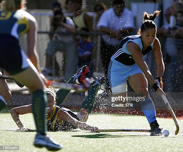 Soledad Garcia , of Argentina, escapes with the ball and leaves Australian Kobe McGurk on the ground during a Champions Trophy field hockey match in...