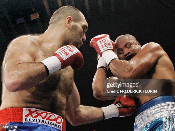 Jameel McCline protects him as Nikolai Valuev fights during their WBA super Heavyweight title match in Jakobshalle 20 January 2007 in Basel,...
