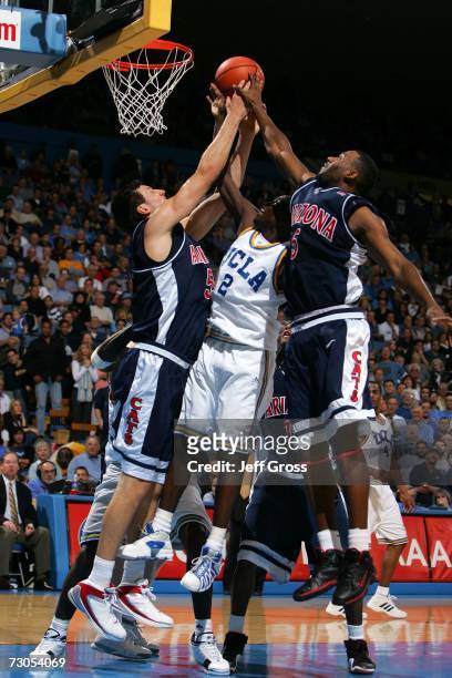Darren Collison of the UCLA Bruins goes up for a rebound between Ivan Radenovic and Jawann McClellan of the Arizona Wildcats in the second half at...