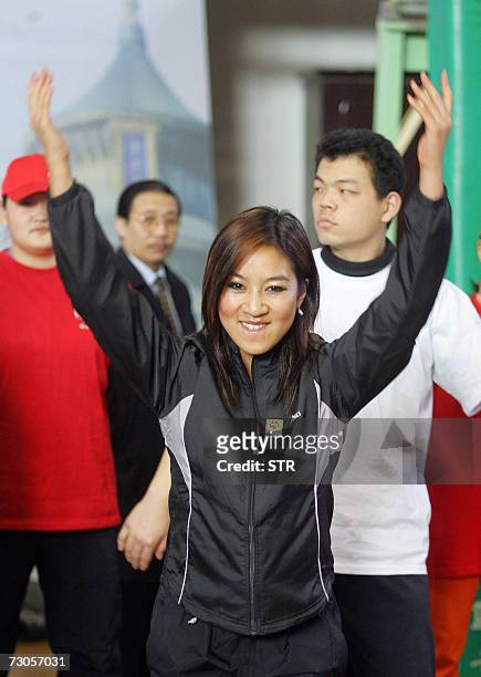 Figure-skating superstar Michelle Kwan interacts with handicapped Chinese athletics in Beijing 21 January 2007. The Hong-Kong born Kwan, a two-time...