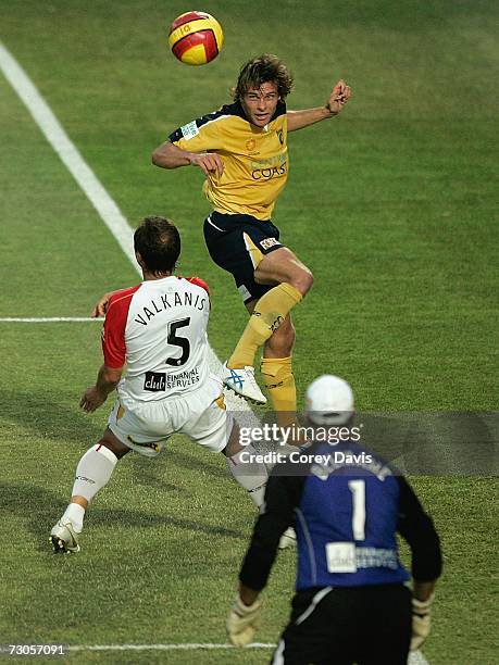 Adam Kwasnik of the Mariners heads the ball over Michael Valkanis of United during round 21 Hyundai A-League match between the Central Coast Mariners...