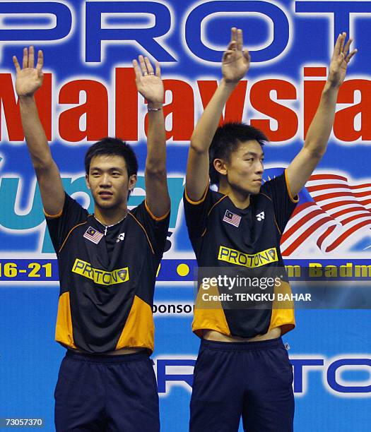 Kuala Lumpur, MALAYSIA: Malaysia's Koo Kien Keat and Tan Boon Heong celebrate at the winner's podium after defeating Indonesia-US doubles team Candra...