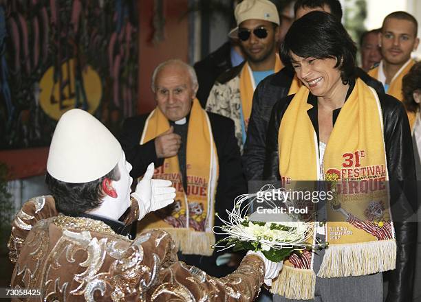 Clown offers flowers to Princess Stephanie of Monaco as she arrives to attend the 31st International Circus Festival of Monte-Carlo on January 21,...
