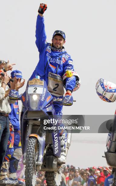 Frenchman rider Cyril Despres celebrates on his KTM on the podium after the 15th and final stage of Dakar's Rally, 21 January. France's Stephane...