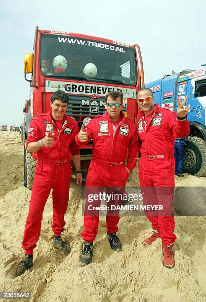 The Netherlands' Hans Stacey flanked by teammates Belgium's Charly Gotlib and compatriot Bernard Der Kinderen give the thumbs up close to their Man...