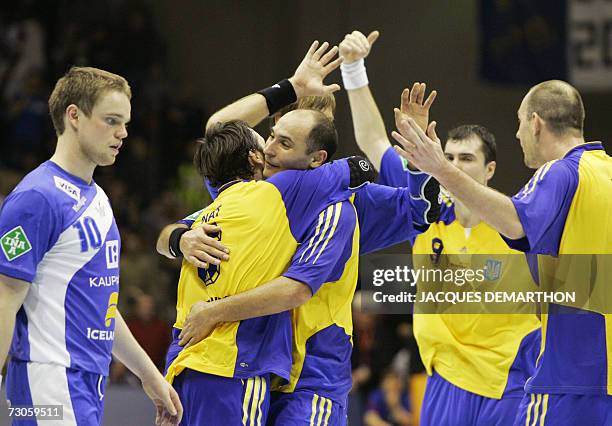 Ukraine's players celebrate after defeating Iceland in their Group B match of the preliminary round of the Men's Handball World Championship, 21...