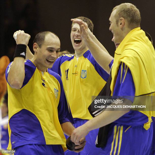 Ukraine's Yuriy Petrenko celebrates with teammates after defeating Iceland in their Group B match of the preliminary round of the Men's Handball...