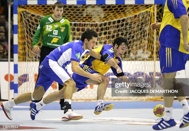 Iceland's Sigfus Sigurdsson vies with Ukraine's Vitaliy Nat during their Group B match during the Ukraine-Iceland Group B match of the preliminary...