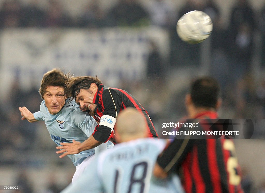 AC Milan's Paolo Maldini (R) fights for