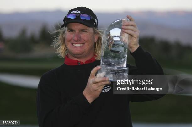 Charley Hoffman celebrates by lifting the winner's trophy after winning the Bob Hope Classic in sudden death play at the Classic Club Golf Course...