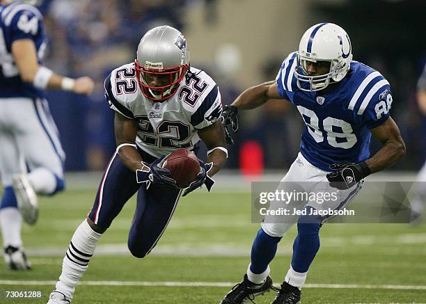 Asante Samuel of the New England Patriots runs back an interception for a touchdown in front of Marvin Harrison of the Indianapolis Colts during the...