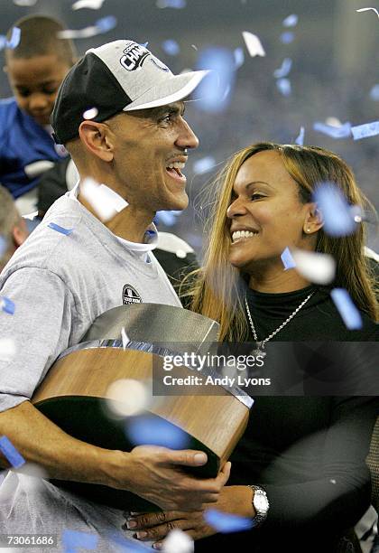 Head coach Tony Dungy of the Indianapolis Colts holds up the AFC Championship trophy as he hugs his wife Lauren Dungy after the Colts defeated the...