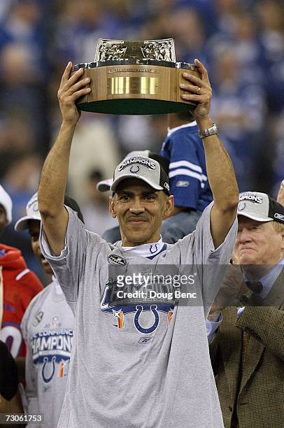 Head coach Tony Dungy of the Indianapolis Colts holds up the AFC Championship trophy after the Colts defeated the New England Patriots 38-34 in the...