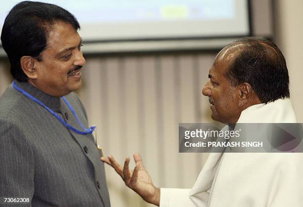Indian Defence Minister A. K. Antony gestures as he talks with Maharastra state Chief Minister Vilas Rao Deshmukh during a meeting in New Delhi, 22...