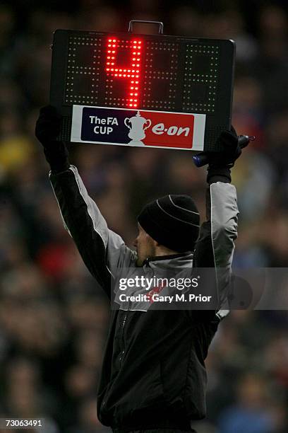 The fourth official indicates 4 minutes of time added on during the FA Cup sponsored by E.ON Third Round Replay match between Manchester City and...
