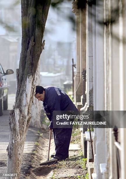 An Algerian worker cleans the French 'Bologhine cemetery' in Algiers City 22 January 2007. AFP PHOTO / Fayez NURELDINE