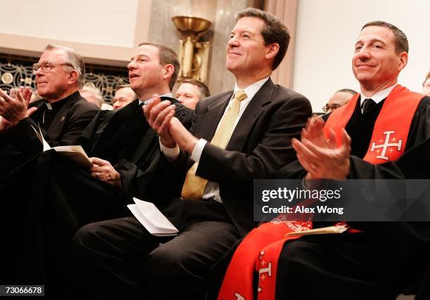 Flanked by National Pro-Life Action Center Director Paul Schenck and Rob Schenck of the National Clergy Council, U.S. Sen. Sam Brownback attends a...